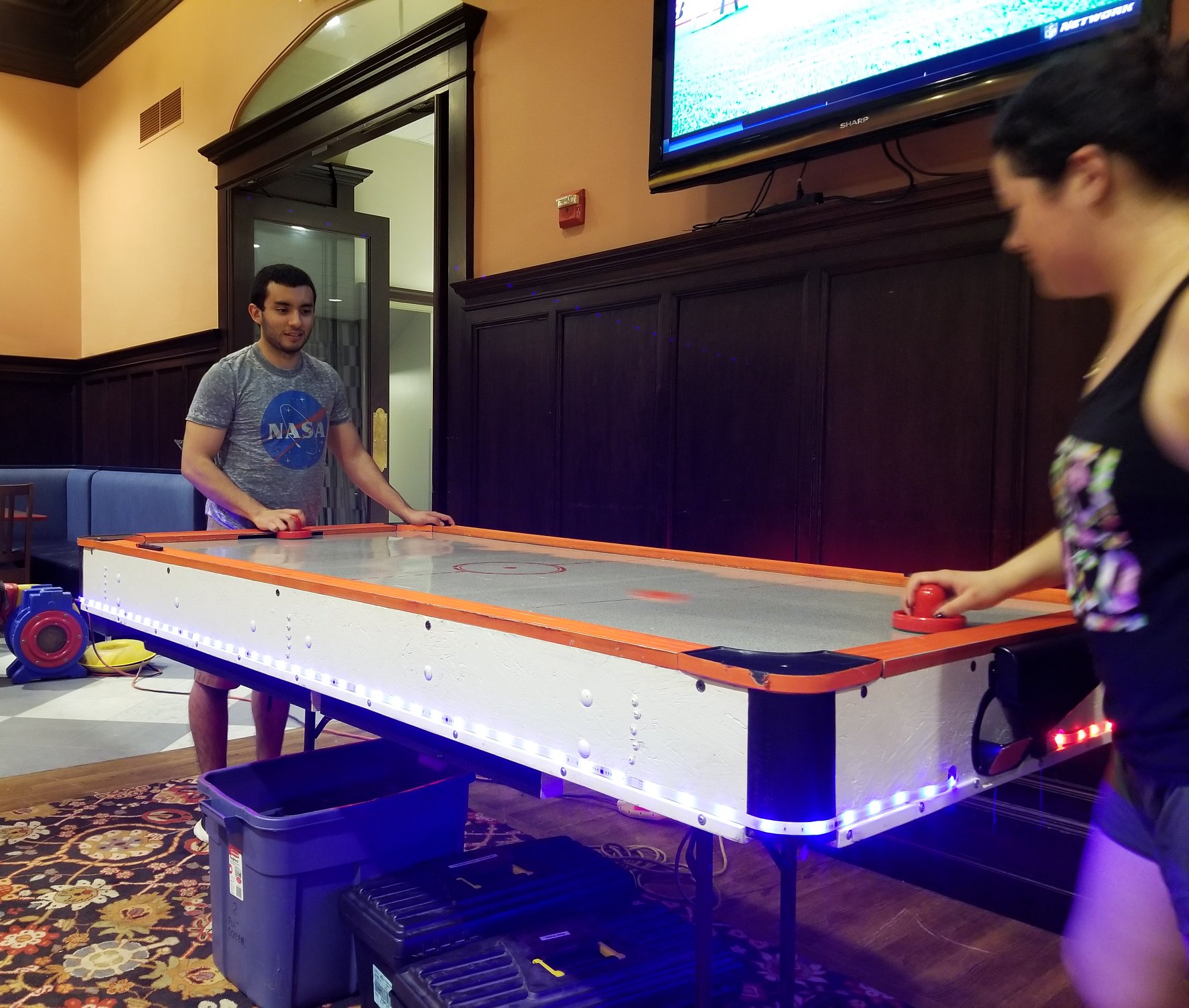 2 Students play Air hockey in the Houston Hall Game Room during the Thing Before Fling
