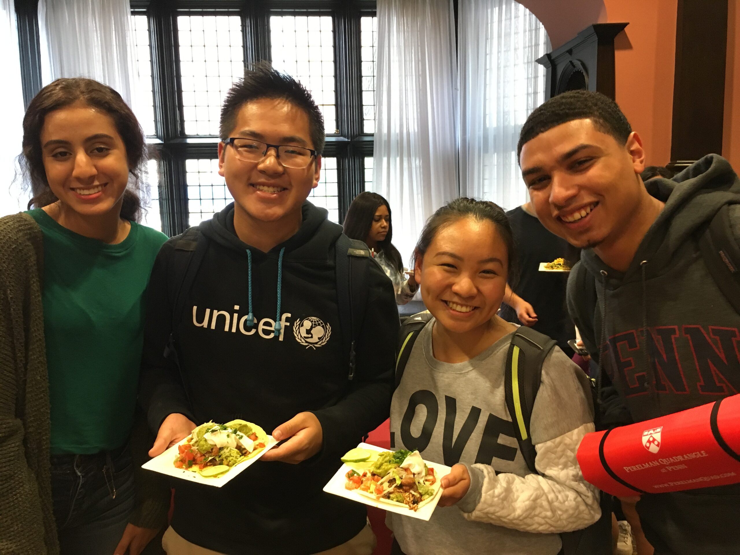 Four Penn Students pose with the food samples given out so they can try the new food at the Houston Market