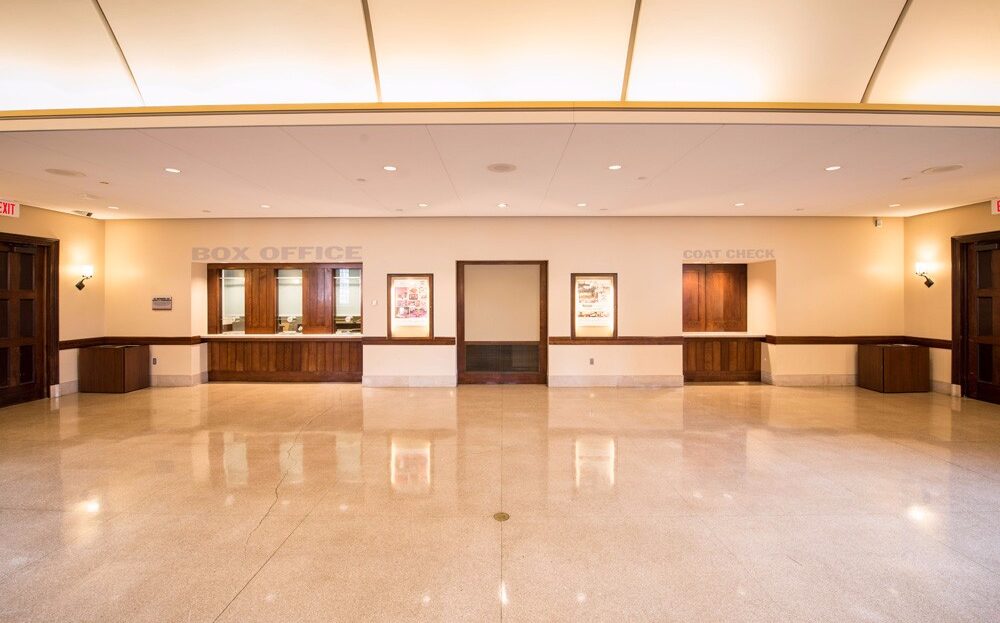 Front Shot of the Irvine 1974 Box Office Lobby showing the box office windows, coat check window, LED display cabinets for show posters and bulletin board for show flyers
